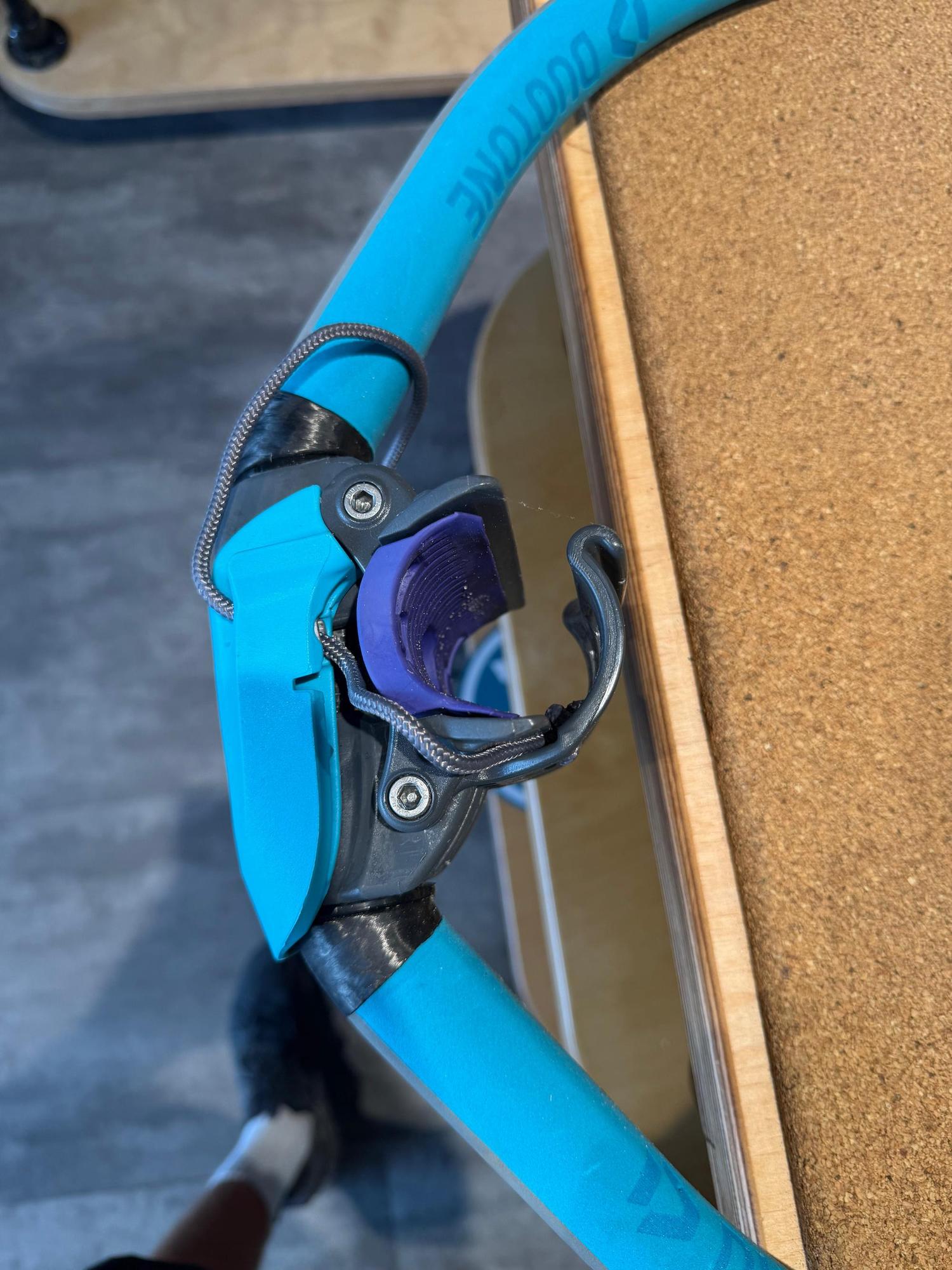 Used Duotone Platinum SLS carbon windsurfing boom head with blue tubing and purple mast cup detail.