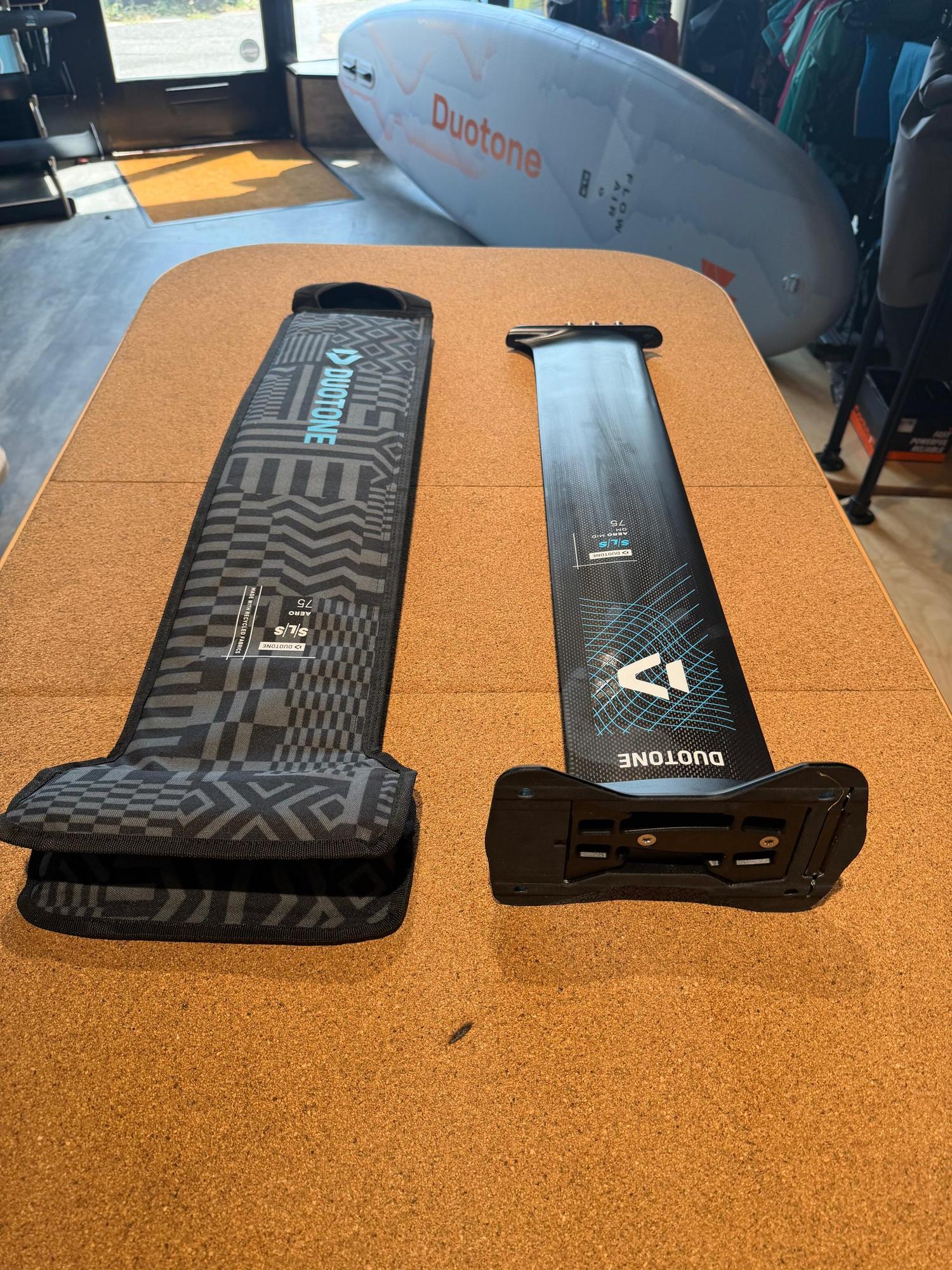 Used Duotone Aero Mid QM SLS 75 carbon foil mast with Quick Mount base and patterned protective storage sleeve.