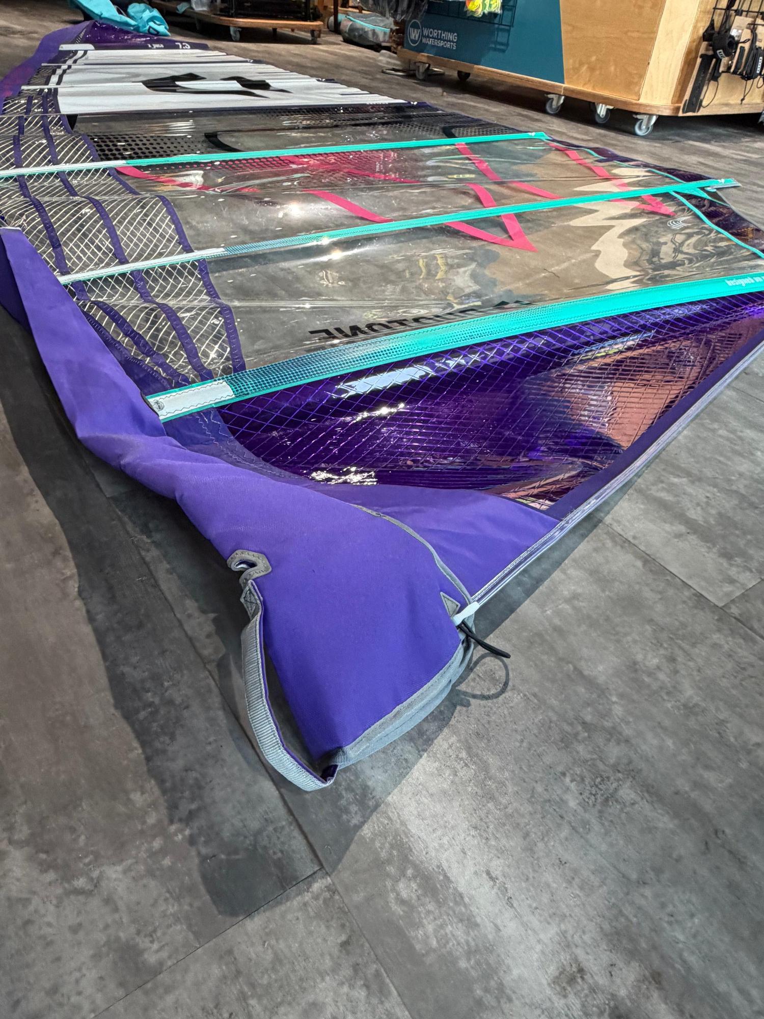 Used Duotone X_Pace 7.3m freerace windsurf sail in purple and clear monofilm with turquoise detailing.