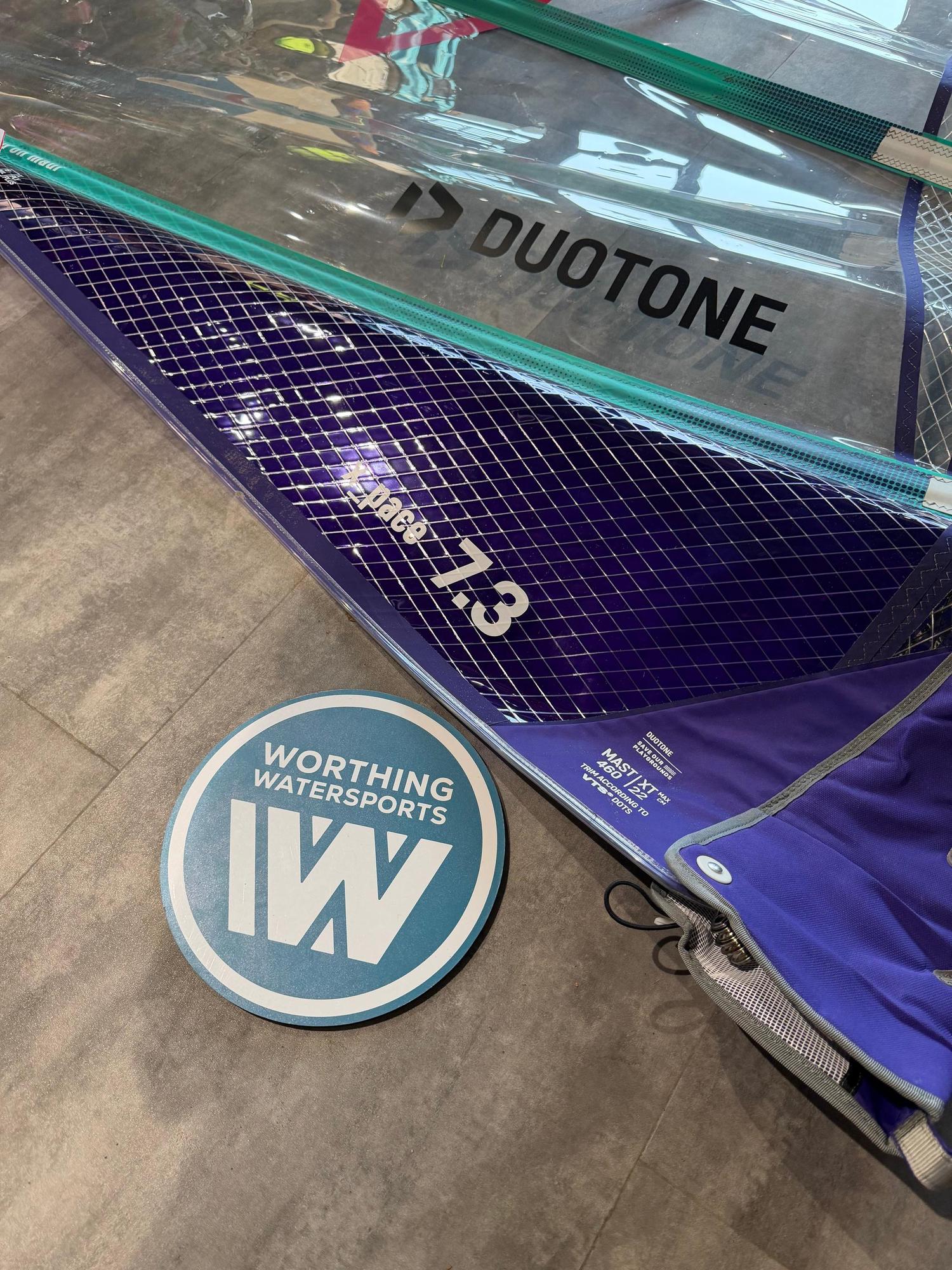 Used Duotone X_Pace 7.3m freerace windsurf sail in purple and clear monofilm with grid reinforcement.
