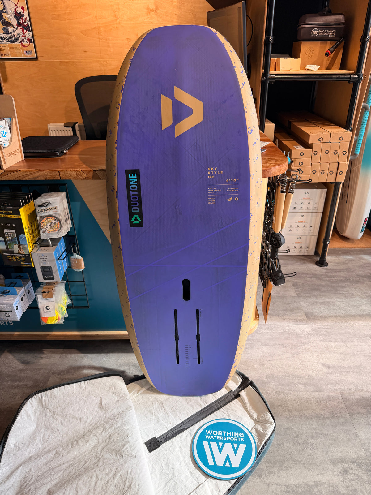 Used Duotone Sky Style SLS 2026 65L foil board in purple and beige with a 4'10" design and foil mounting tracks.