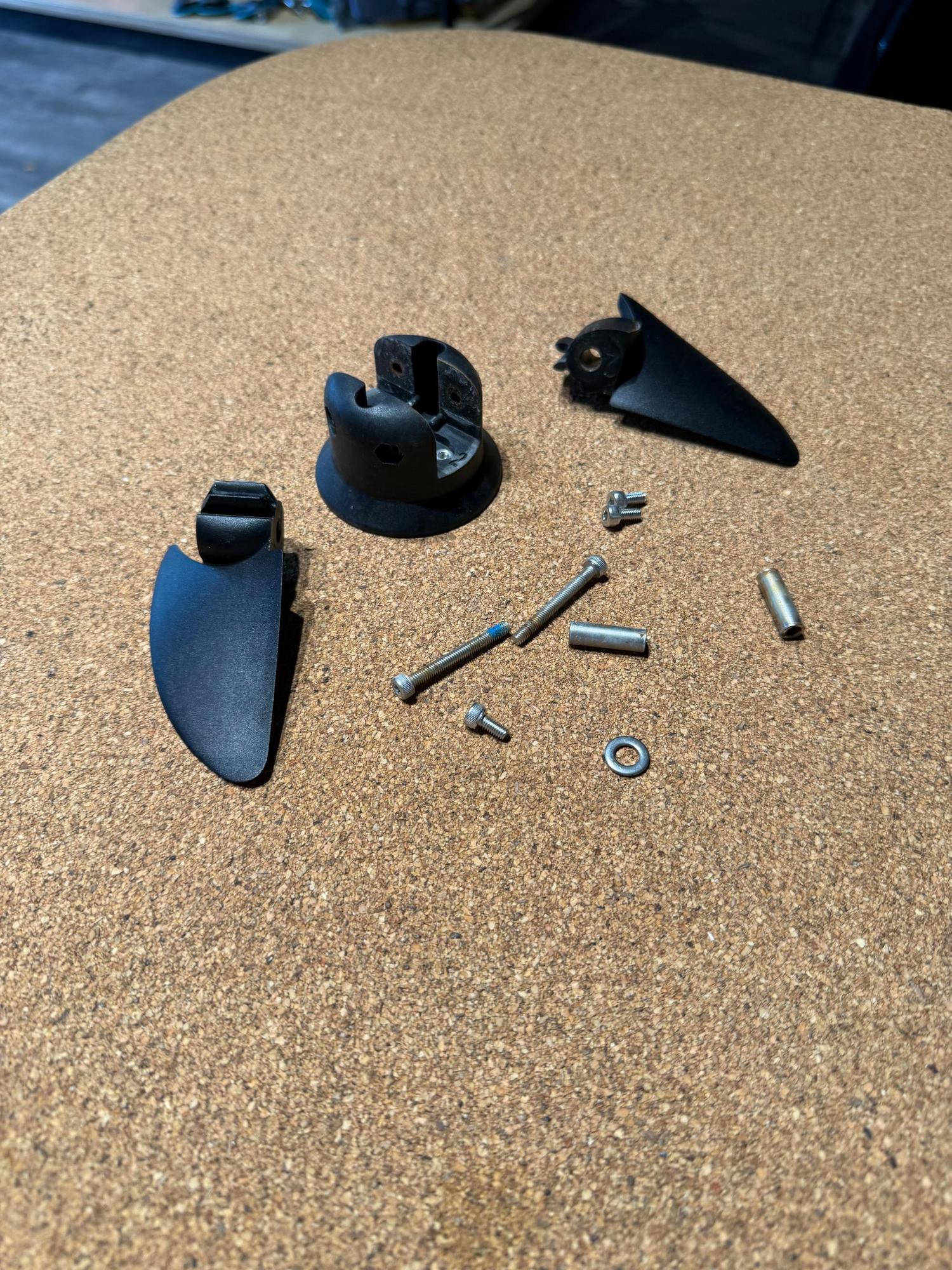 Used Duotone Foil Assist ePropeller set with two black aluminium blades, mounting hub, and assorted metal screws and fixings.