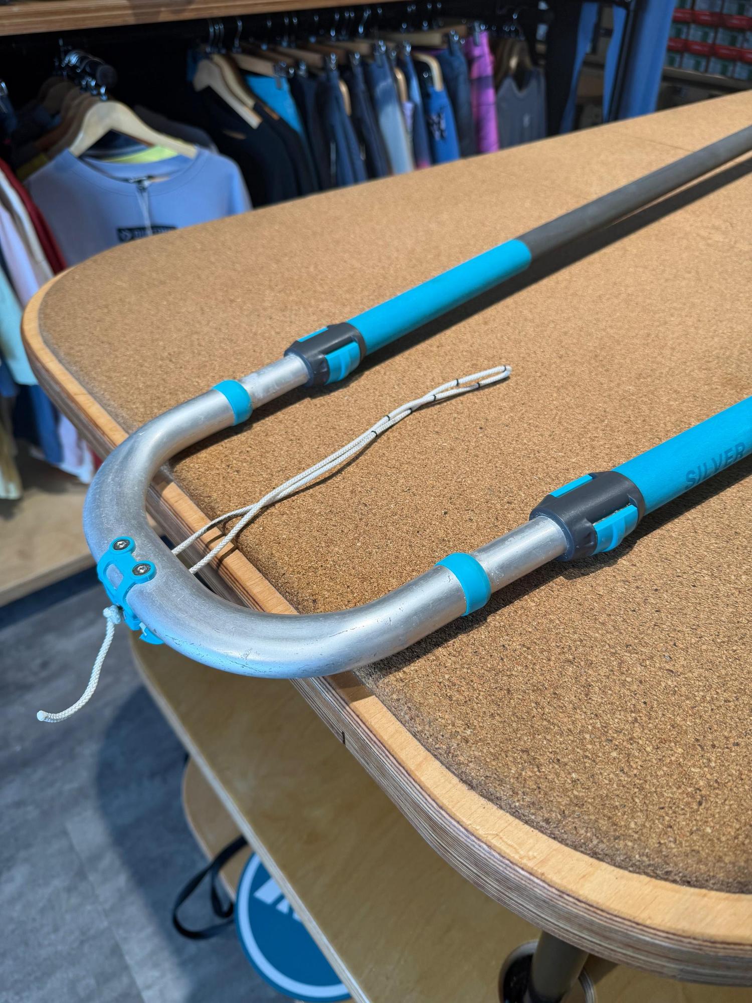 Used Duotone Silver Series Mega.Slim 140-200 windsurfing boom in silver and blue, featuring adjustable arms and grip detail.