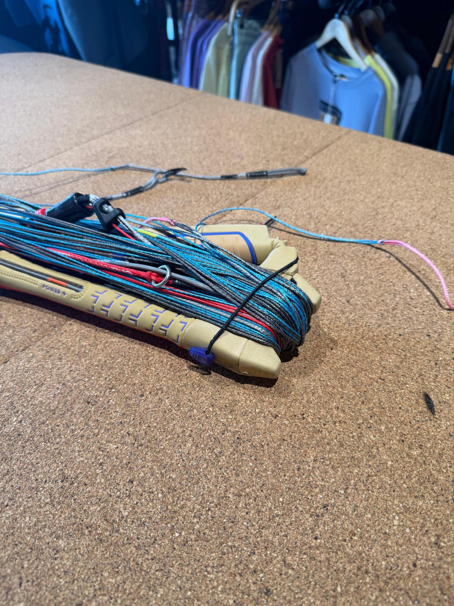 Used Duotone Click Bar 2026 S size with wound multi-coloured lines and tan grip on a cork surface.