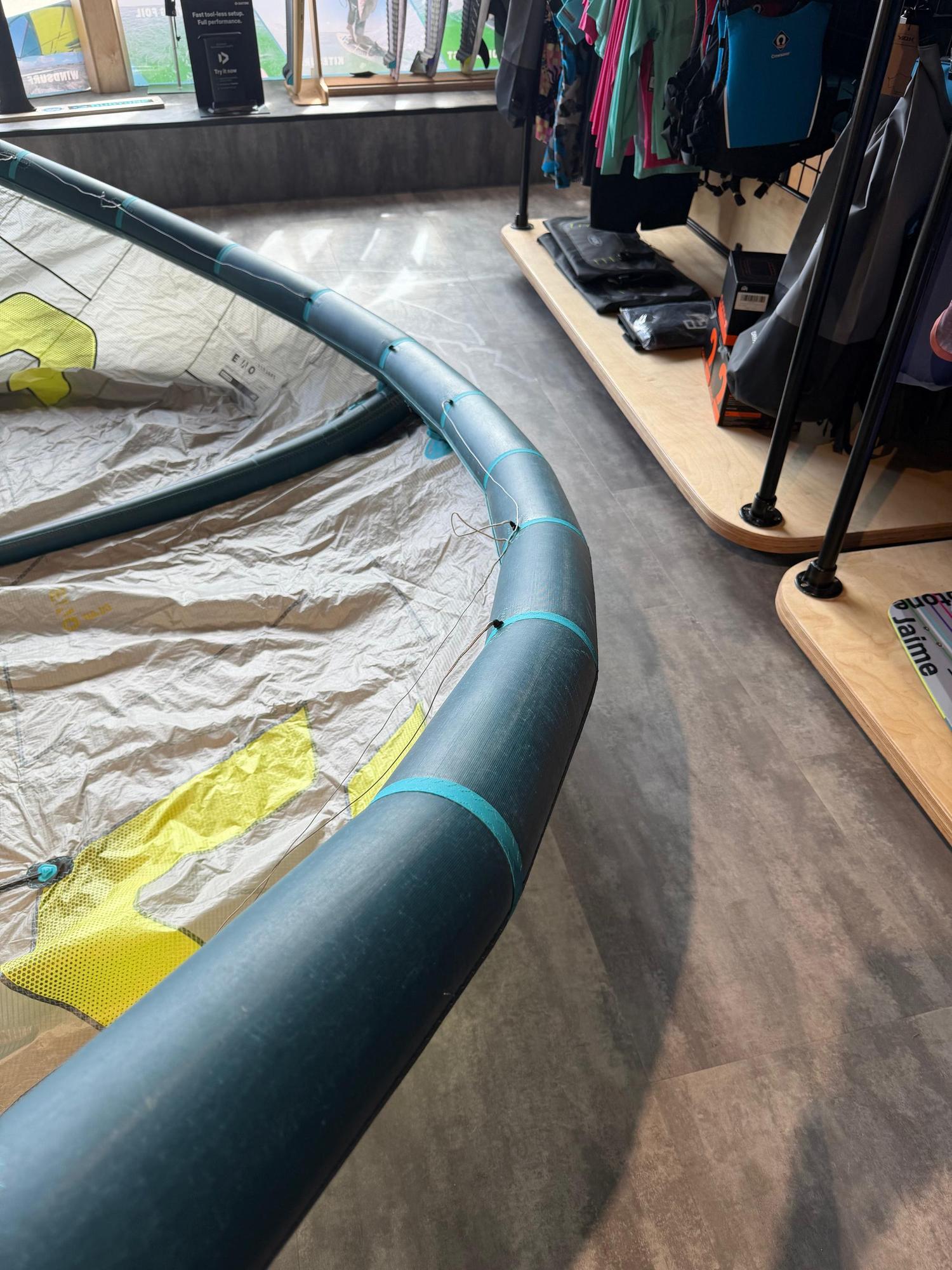 Used 8m Duotone Evo DLAB kite in blue and grey with Trinity TX fabric, displayed on a shop floor.