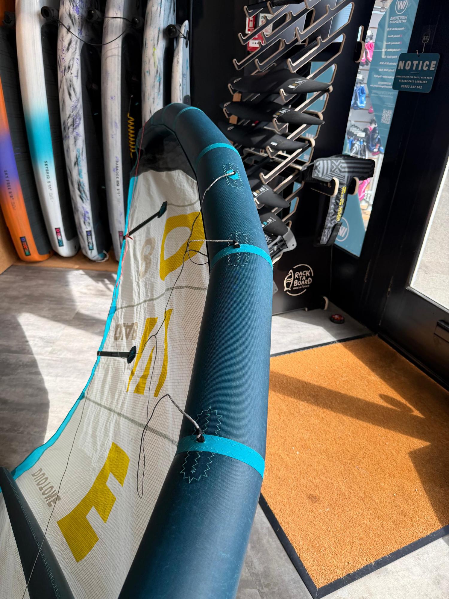 Used 8m Duotone Evo DLAB kite in blue and white with Aluula Gold and Trinity TX fabric in a retail shop setting.
