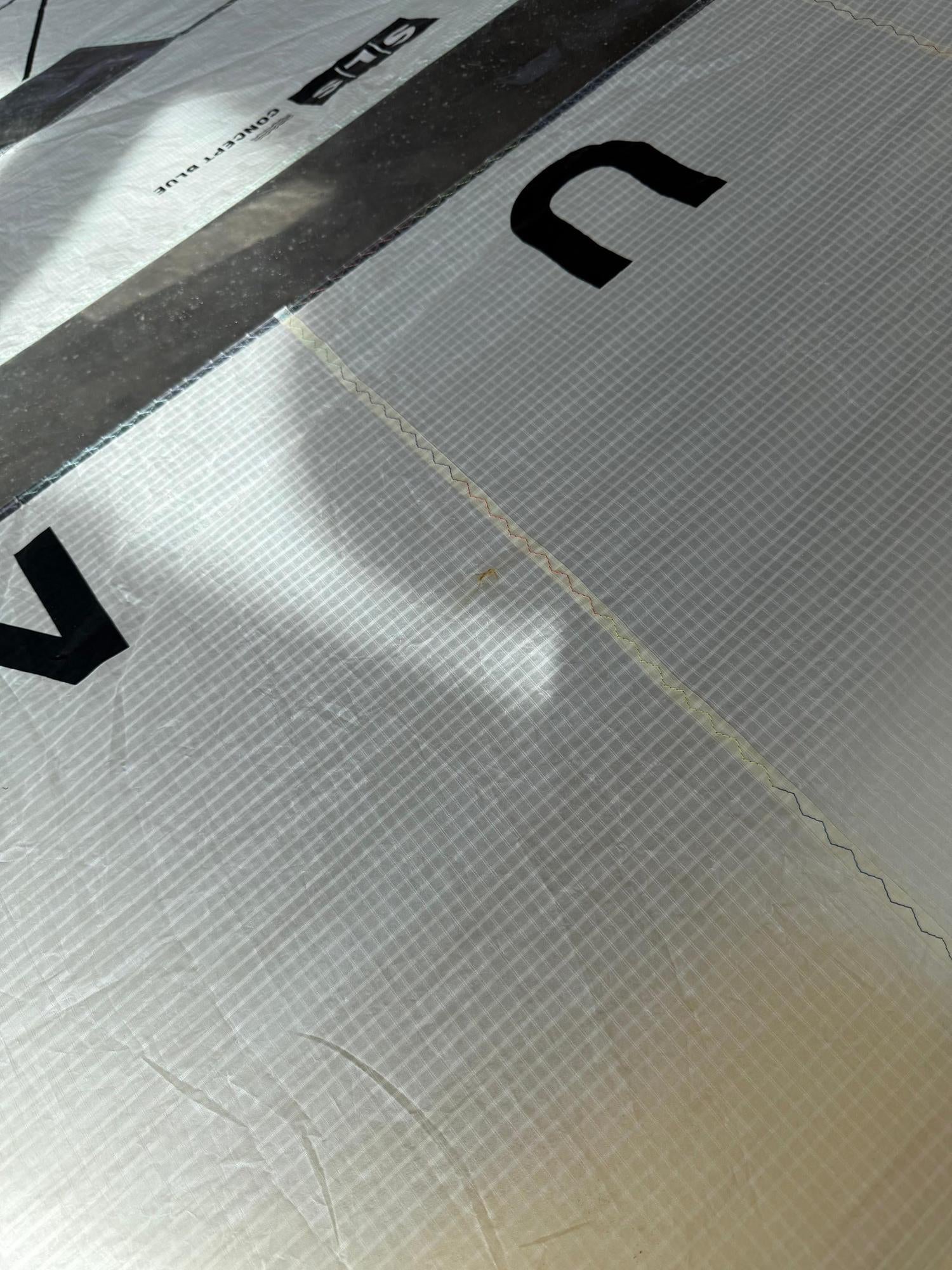 Close-up of the white grid-patterned canopy on a 2026 Duotone Unit SLS Concept Blue wing with visible branding.