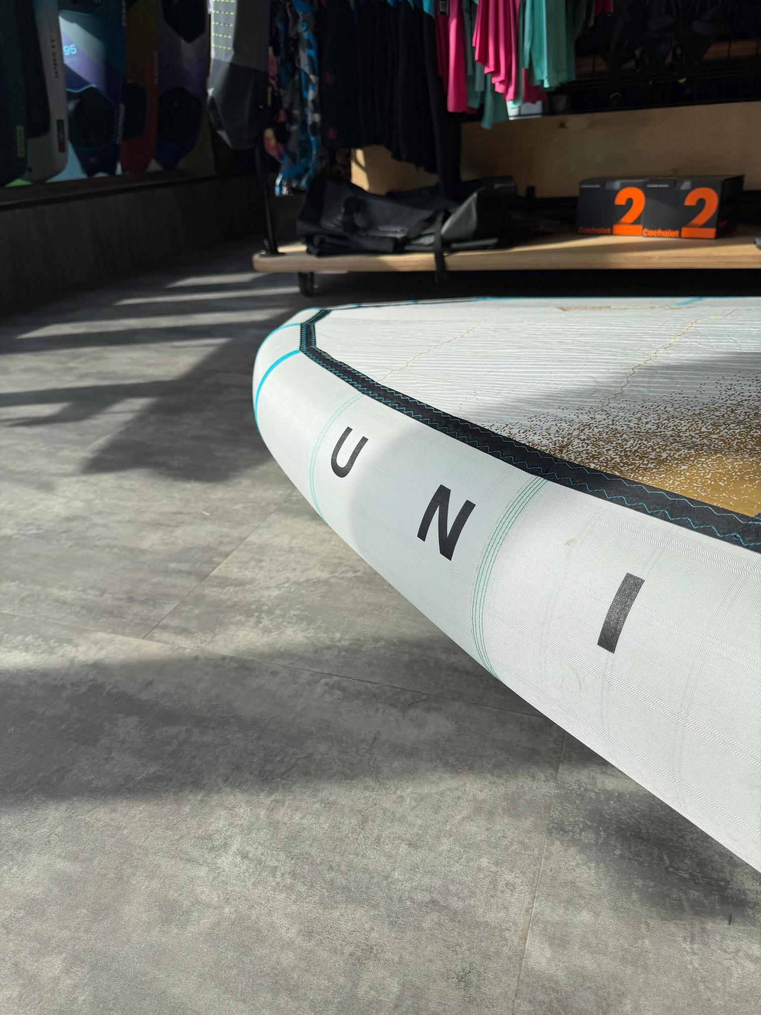 White Duotone Unit SLS 6.5M Concept Blue wing leading edge with black lettering and professional repair detail.
