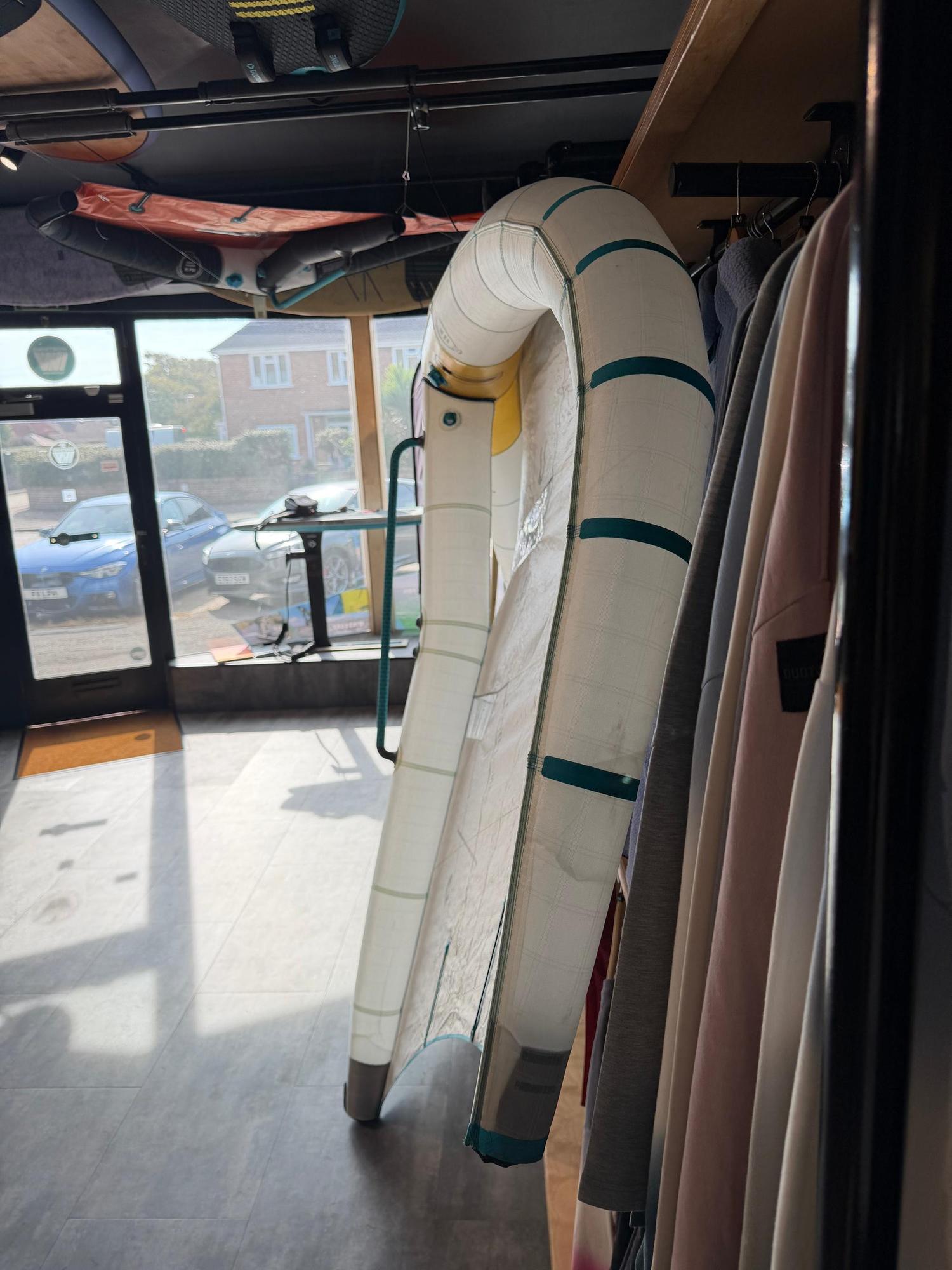 Used 6.5m Duotone Unit SLS Concept Blue wing with white leading edge and fusion boom, displayed in a retail shop.