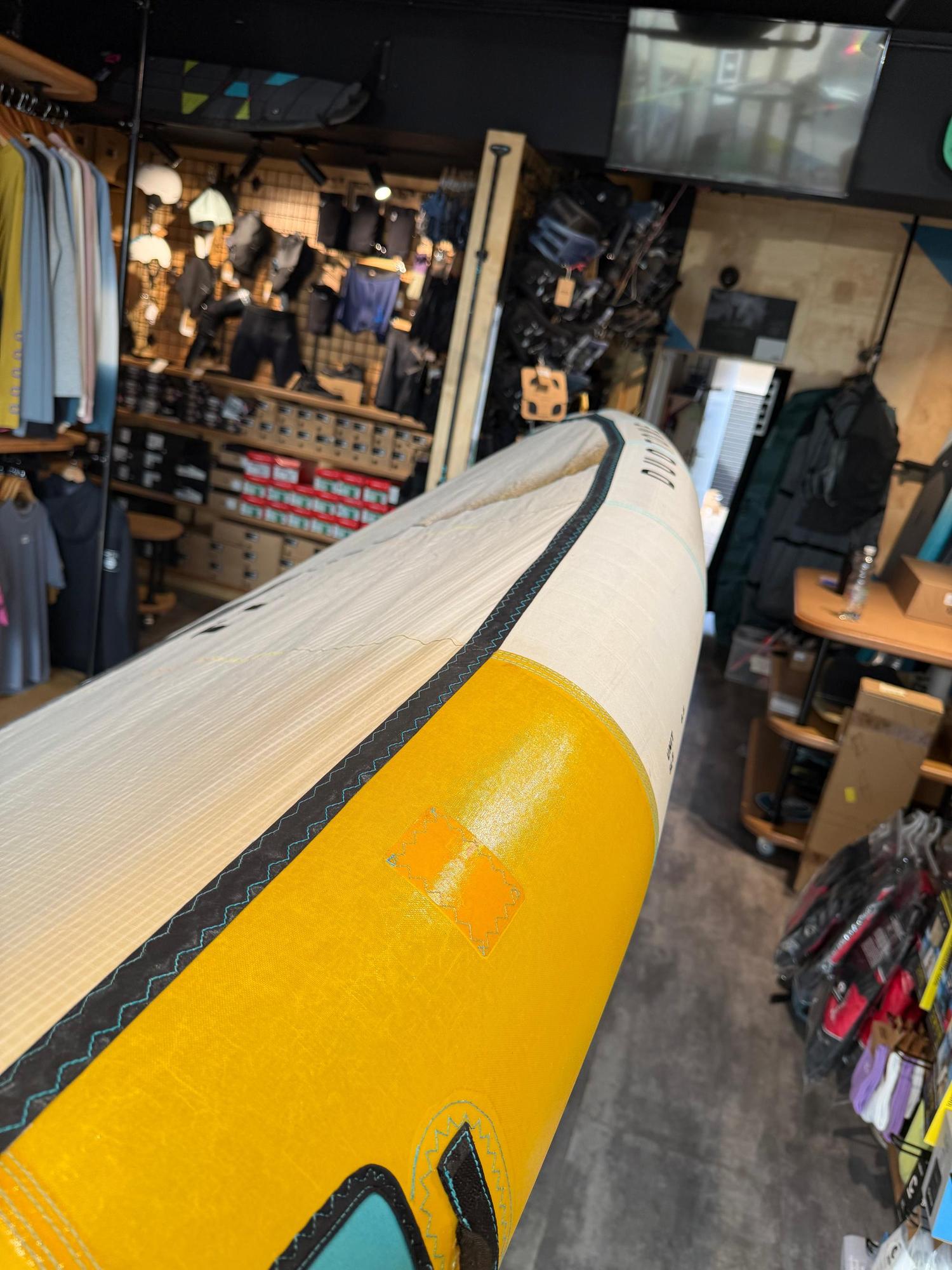 Used 2026 Duotone Unit SLS 6.5m Concept Blue wing showing a professional leading edge repair in a retail shop setting.