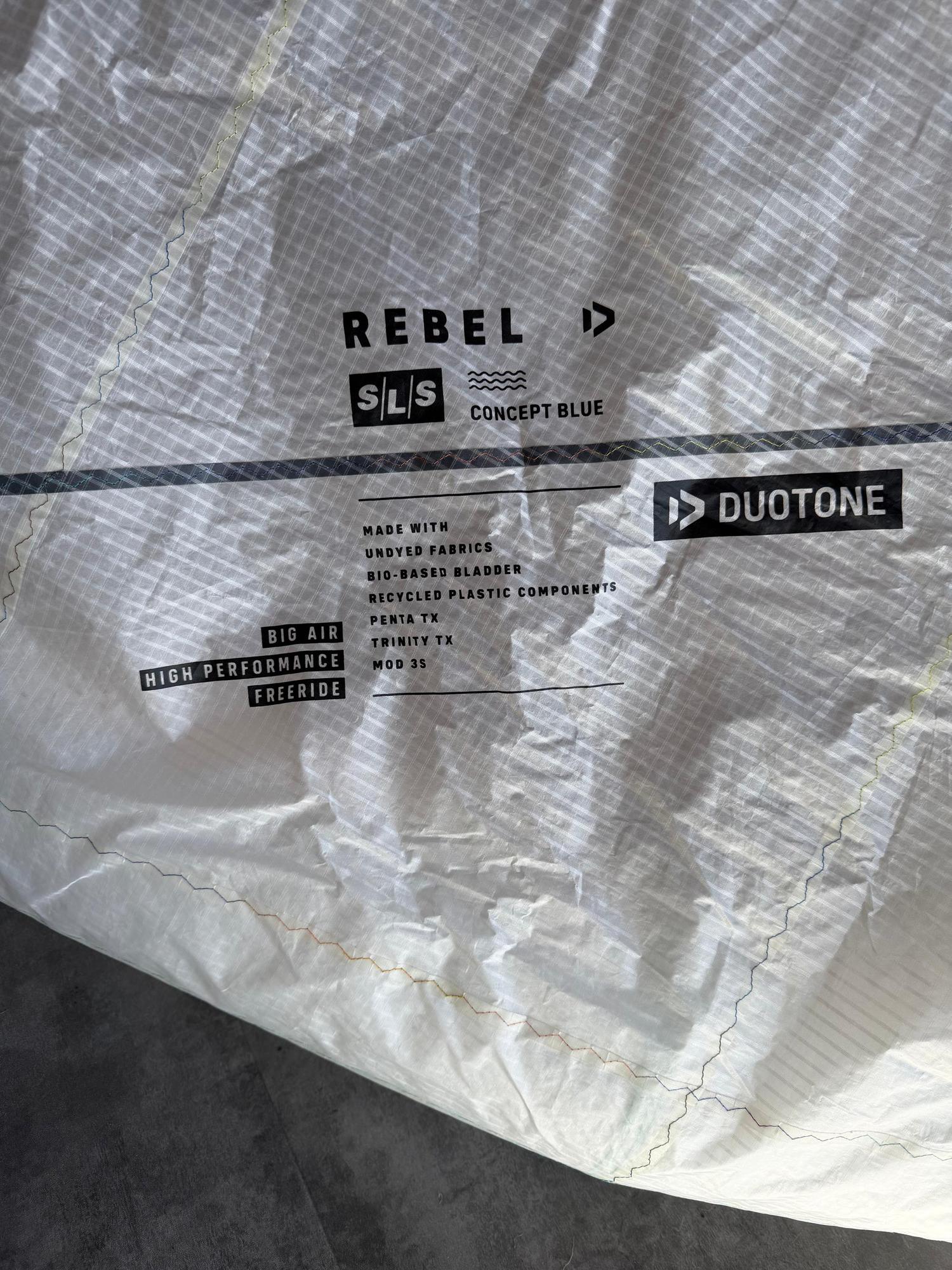Close-up of white Duotone Rebel SLS Concept Blue kite fabric featuring technical branding and material specifications.