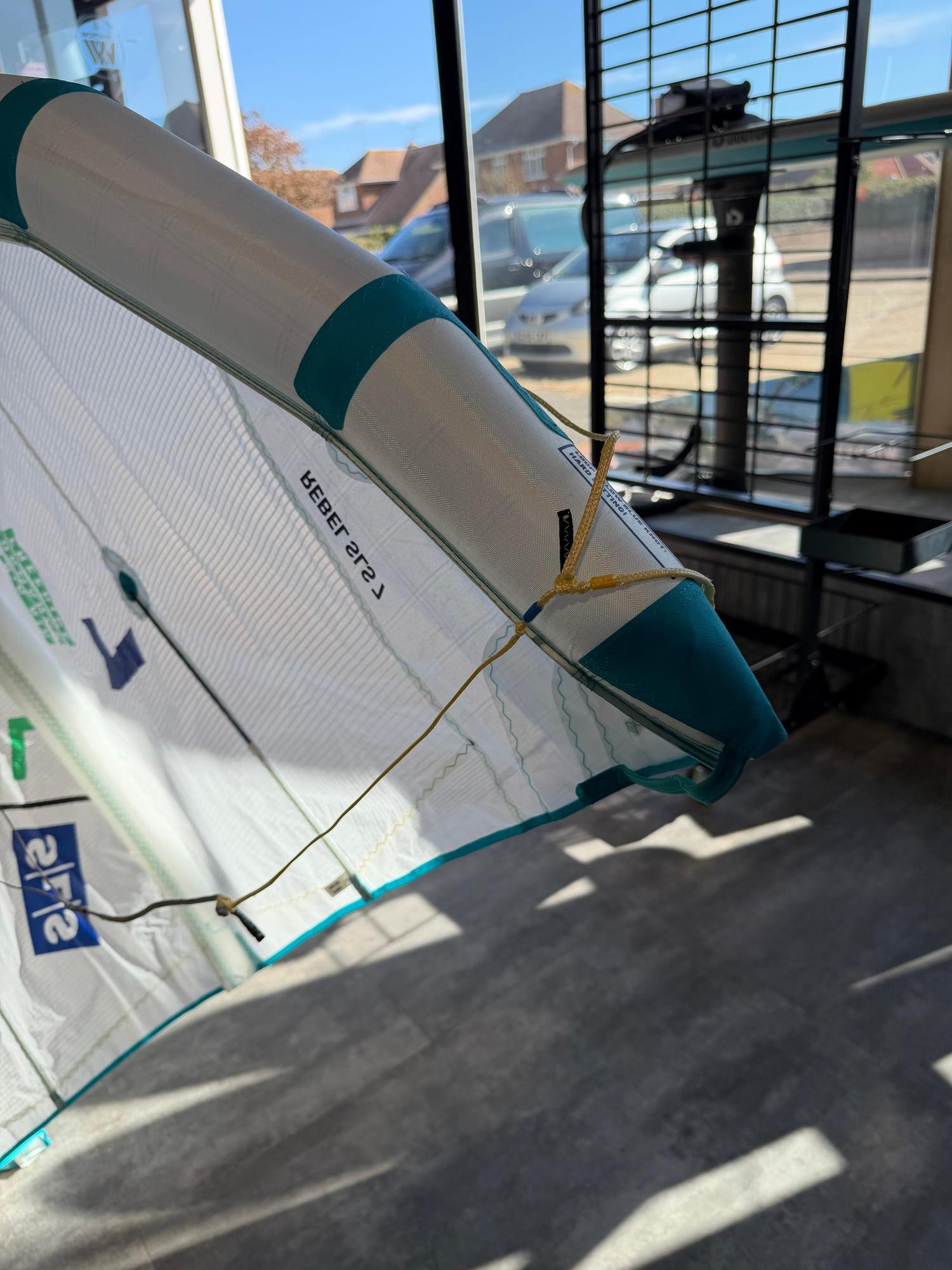 Used 7m Duotone Rebel SLS Concept Blue kite in white with teal accents, featuring Penta TX material and bridle lines.