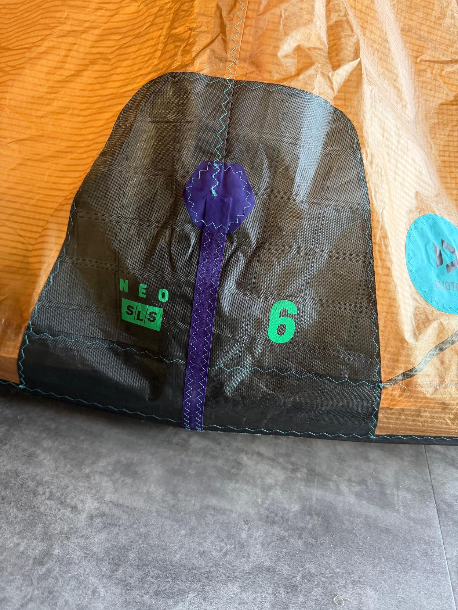 Used 6m Duotone Neo SLS wave kite in orange and black, featuring reinforced stitching and branded canopy detailing.
