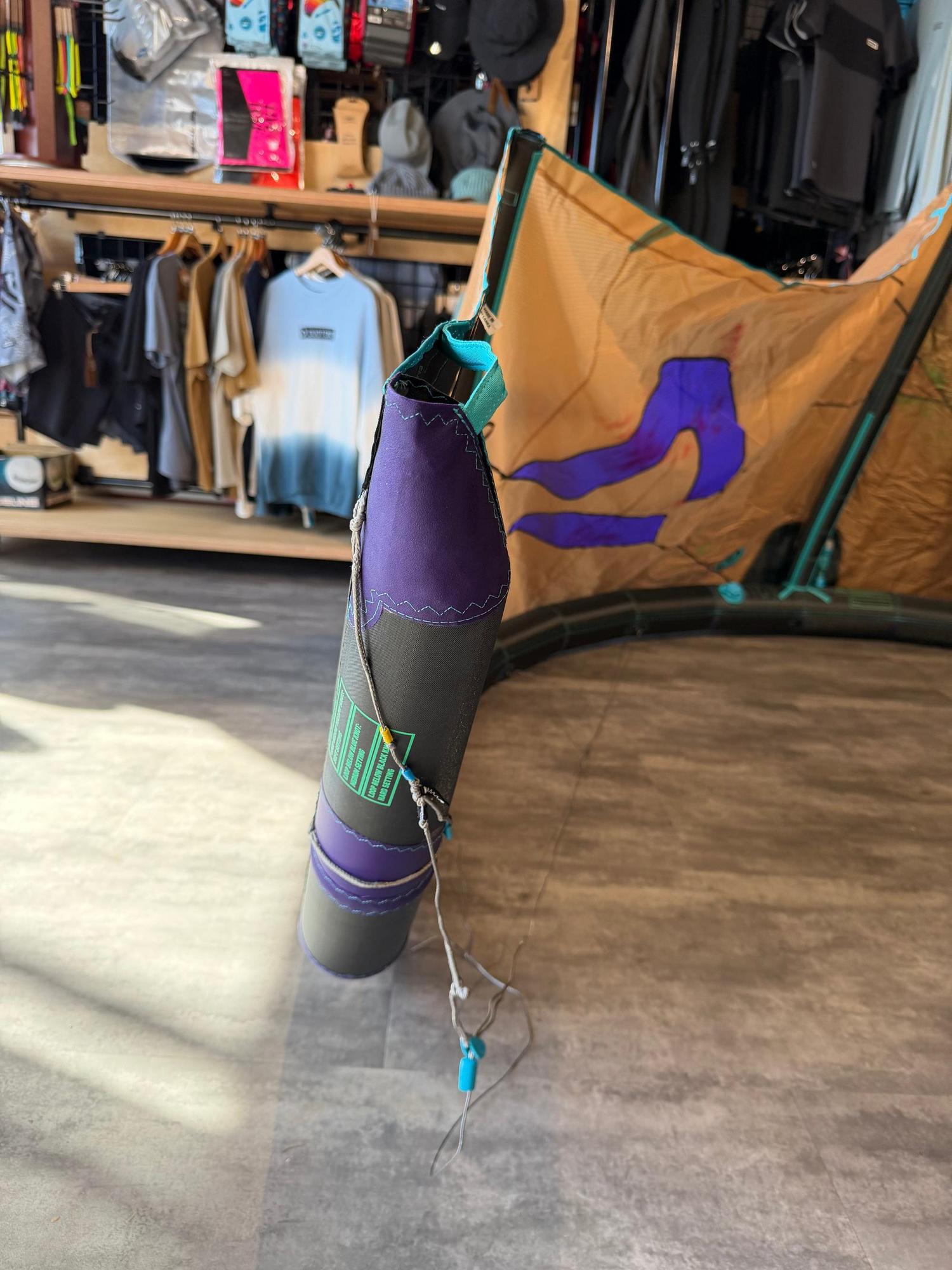 Used 6m Duotone Neo SLS wave kite in purple and tan with teal accents, showing strut construction and rigging details.