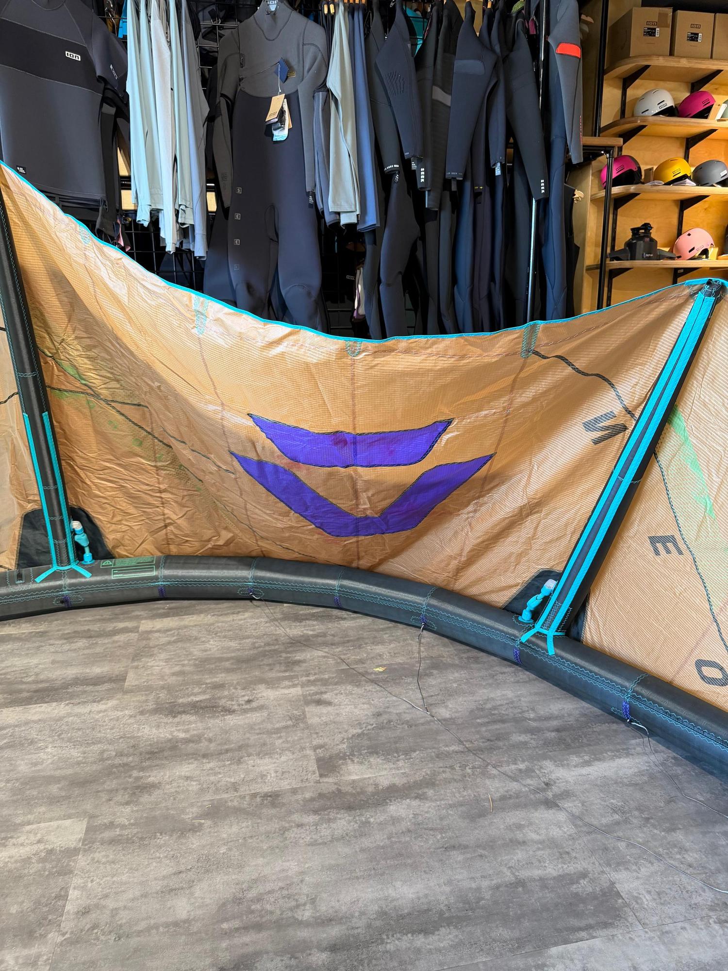 Used 6m Duotone Neo SLS wave kite in tan with purple branding, black struts, and teal accents on a grey floor.