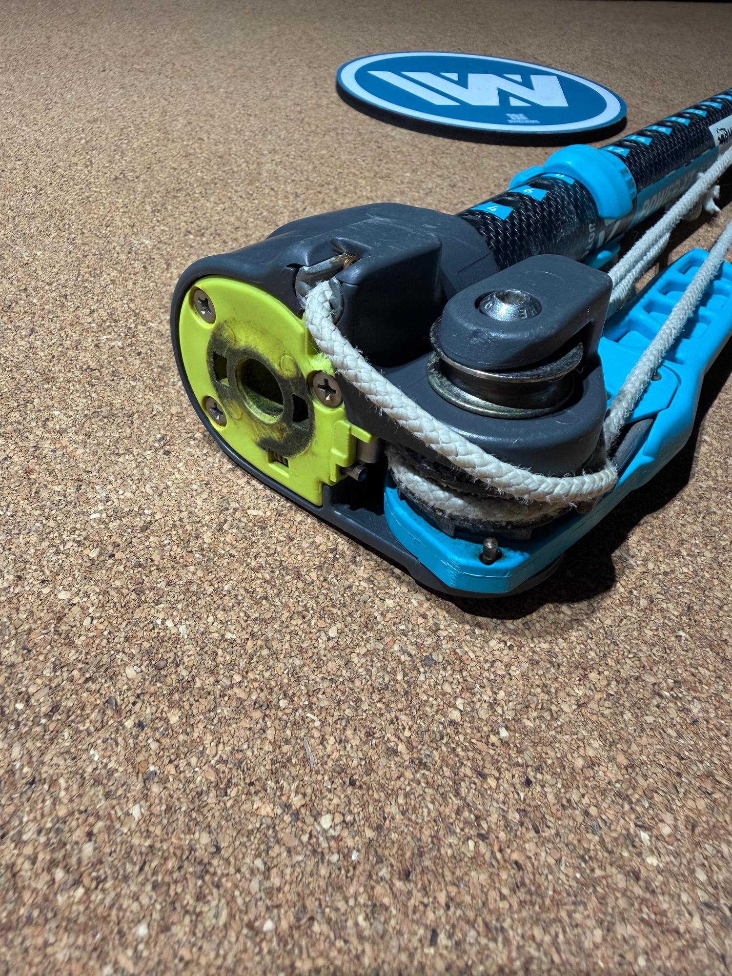 Used Duotone Power.XT 2.0 SLS carbon windsurfing extension with blue ratchet system and RDM 36 tube on a cork surface.