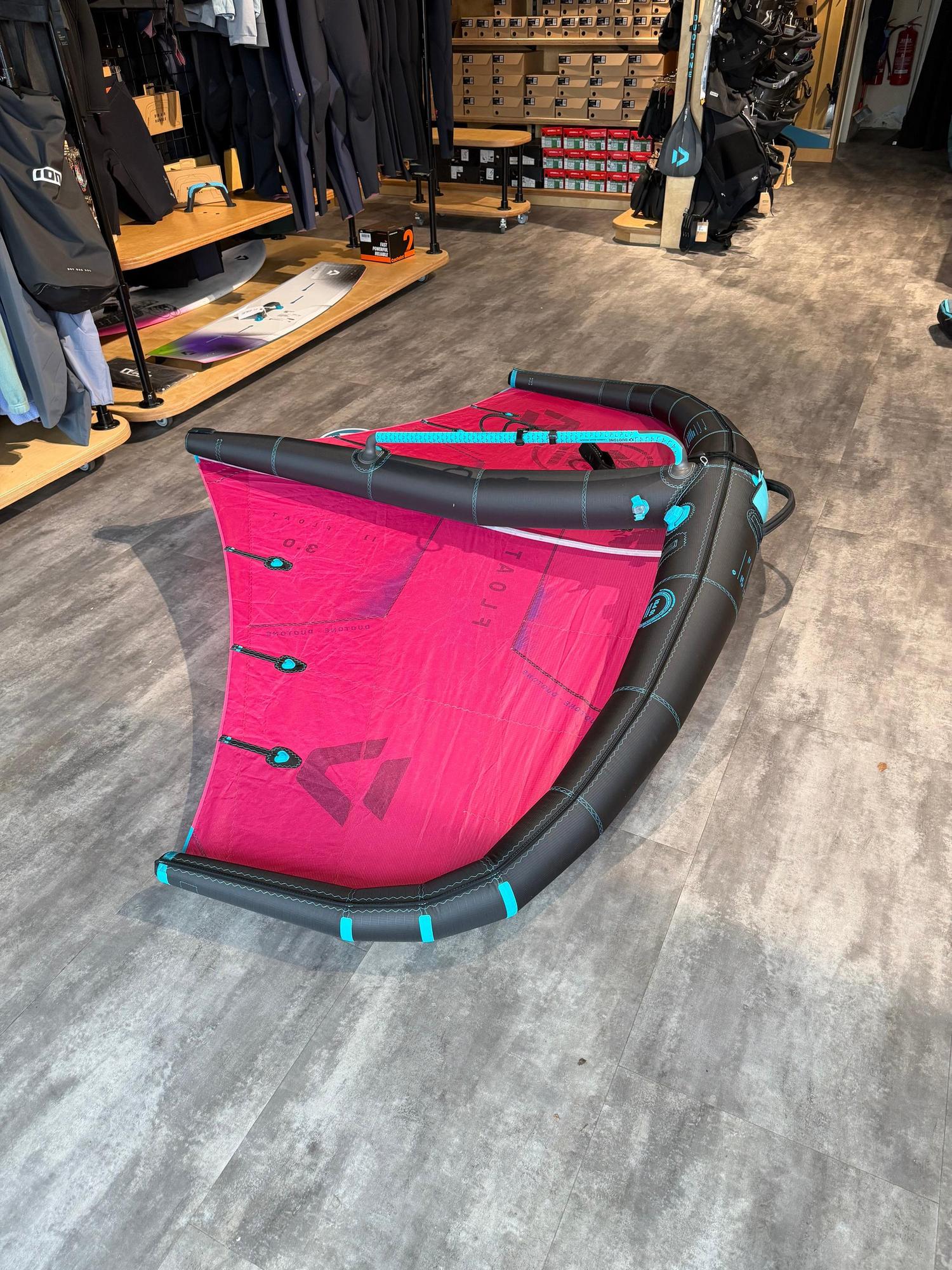 Used 3m Duotone Float wave wing in pink and black with a central boom, displayed on a shop floor.