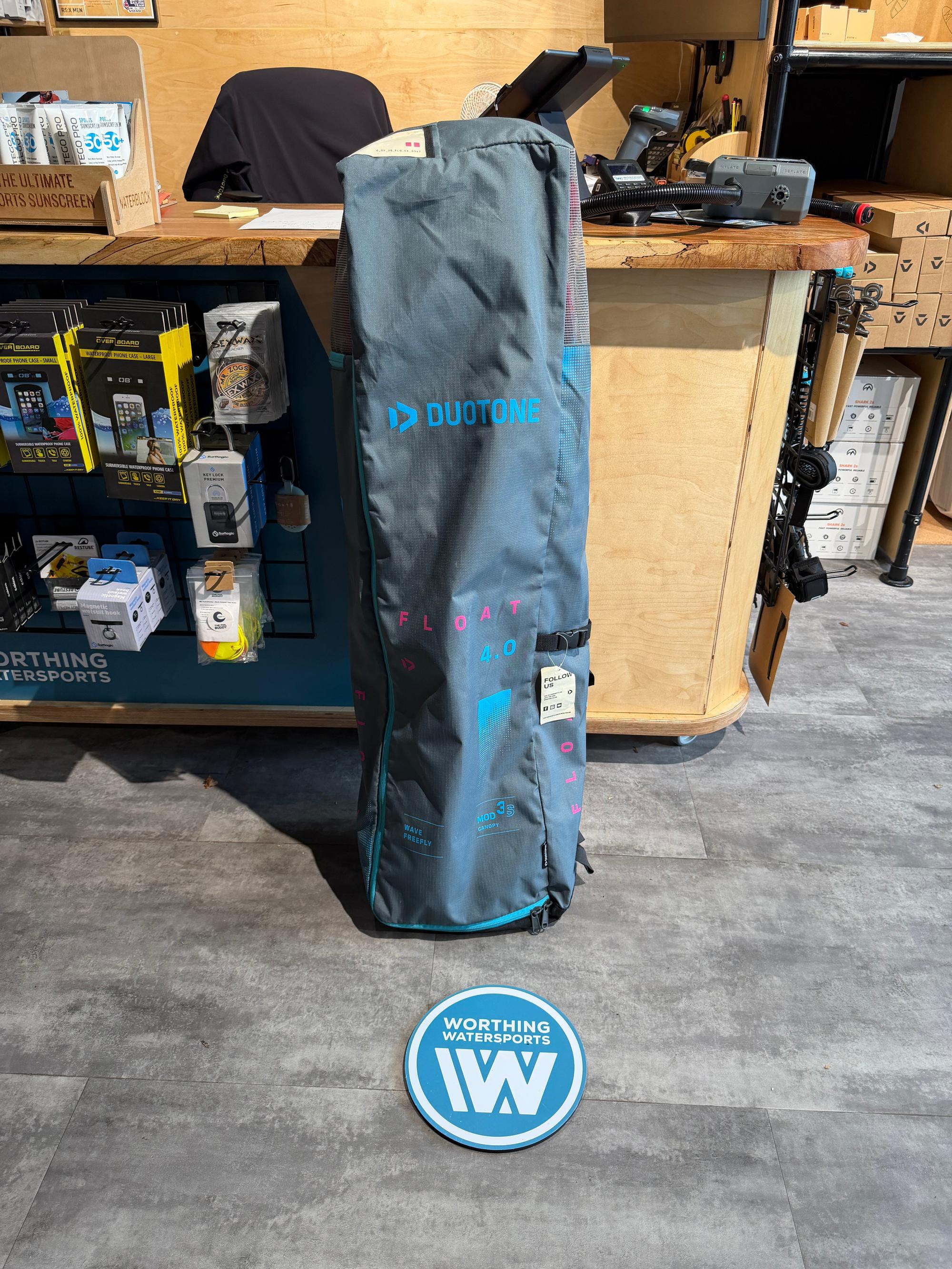 Grey Duotone Float 4m wave wing packed in its branded storage bag, featuring blue logo detailing and mesh ventilation.