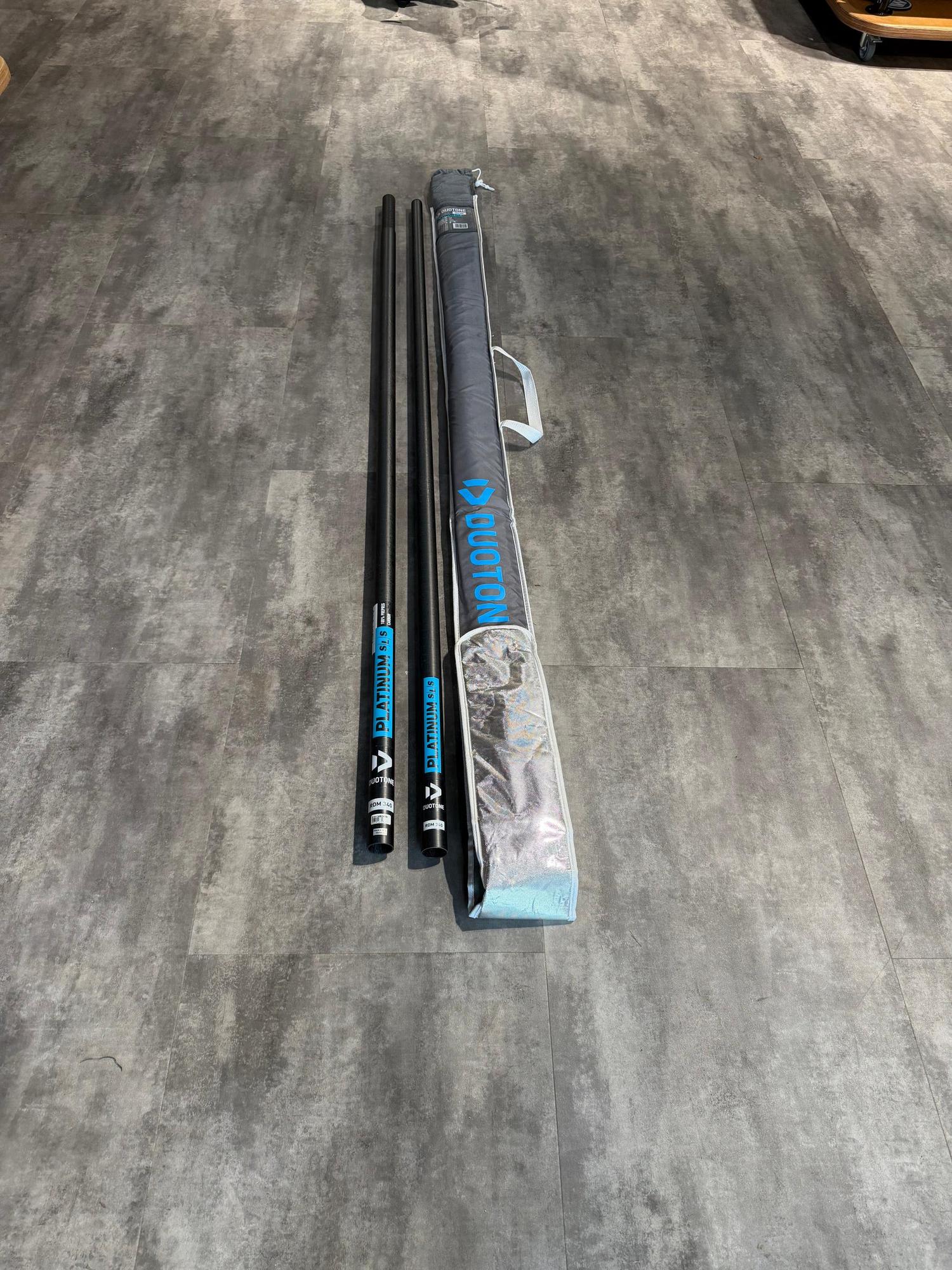 Used Duotone Platinum SLS 340cm RDM windsurfing mast in two pieces with a grey branded storage bag.