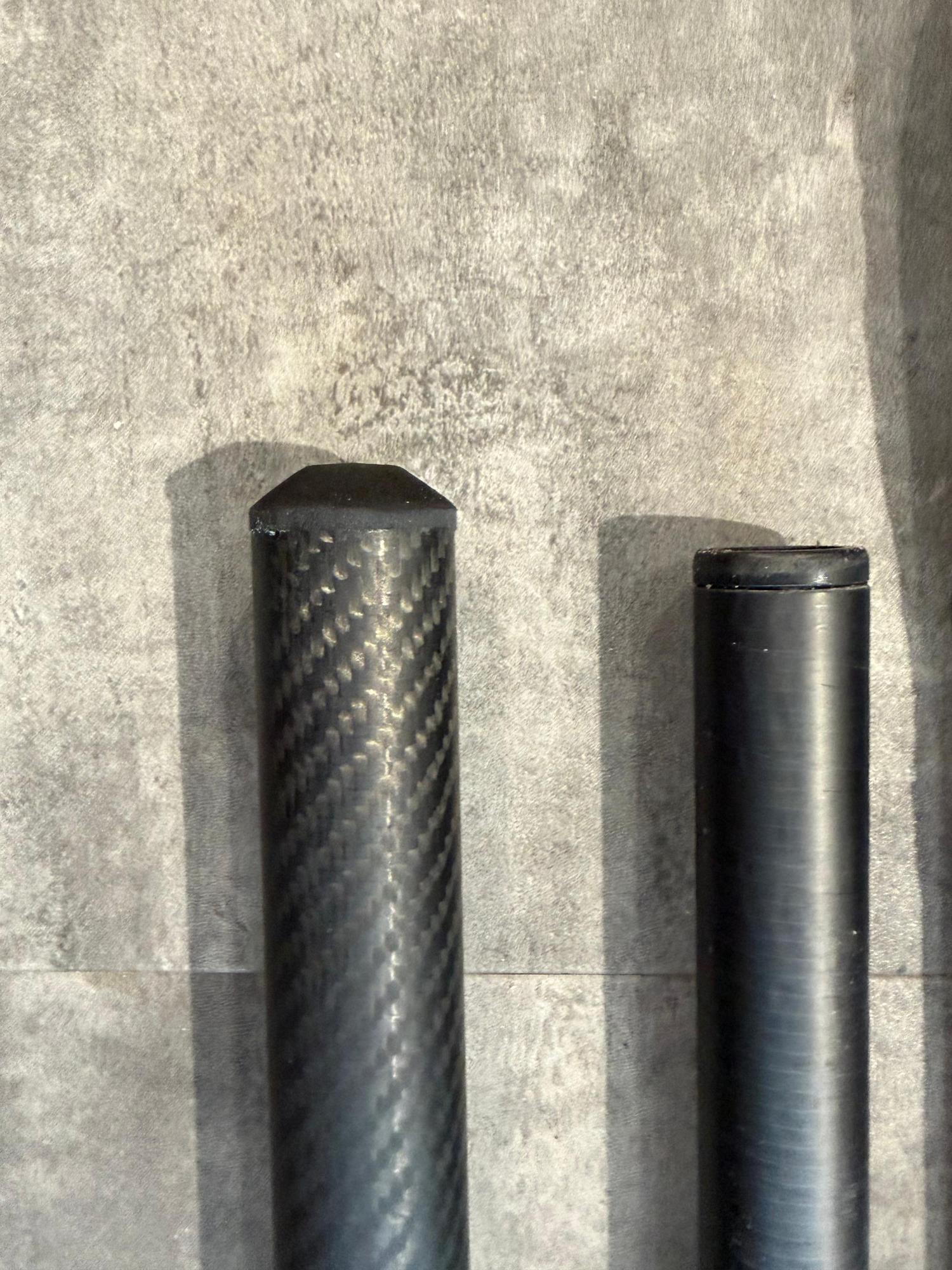 Two-piece Duotone Platinum SLS RDM 340cm windsurfing mast featuring a visible 100% carbon fibre weave texture.