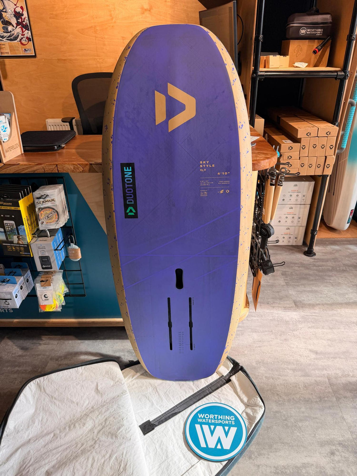 Used Duotone Sky Style SLS 2026 65L foil board in purple and beige with a 4'10" design and foil mounting tracks.