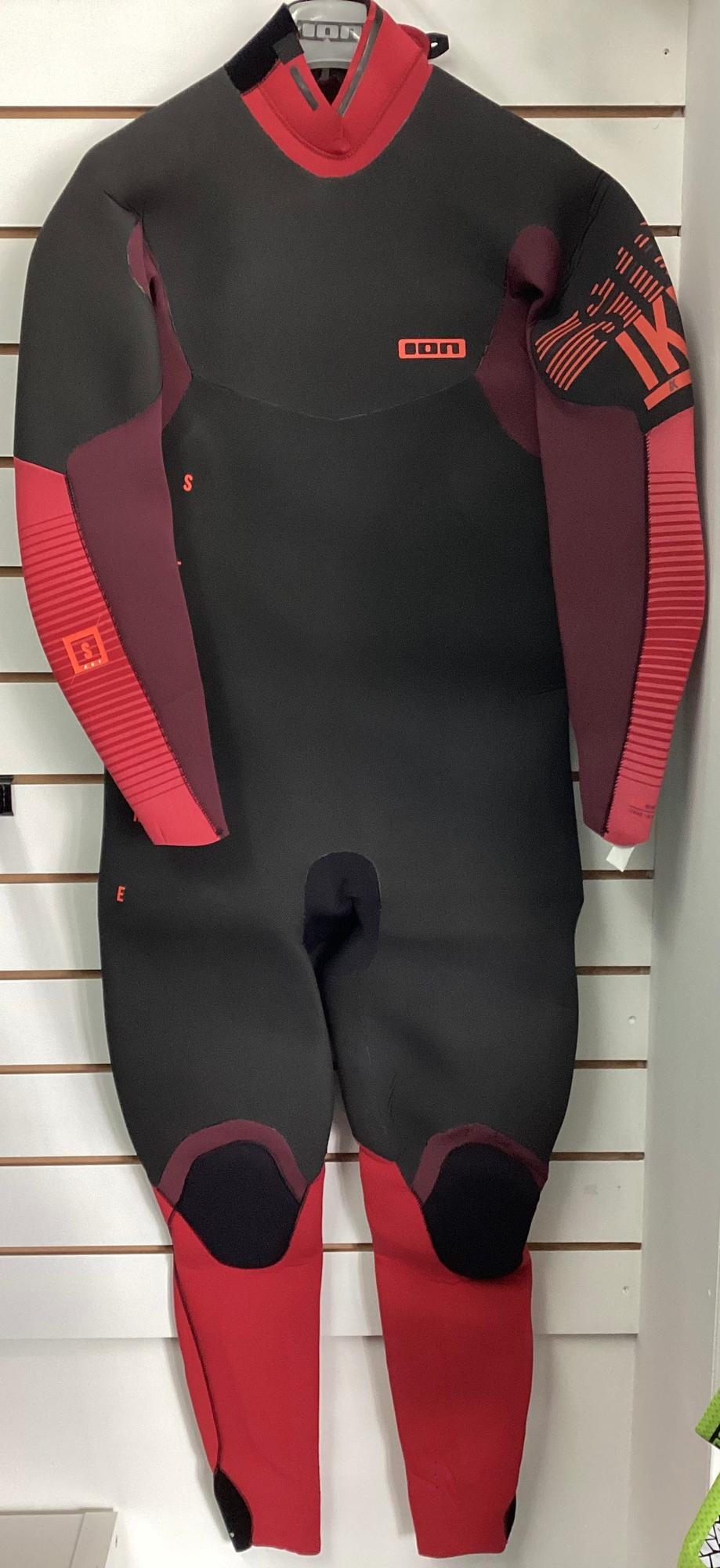 ION Strike Amp Skin 5/4 winter wetsuit in black and red with long sleeves, reinforced knee pads, and branded detailing.